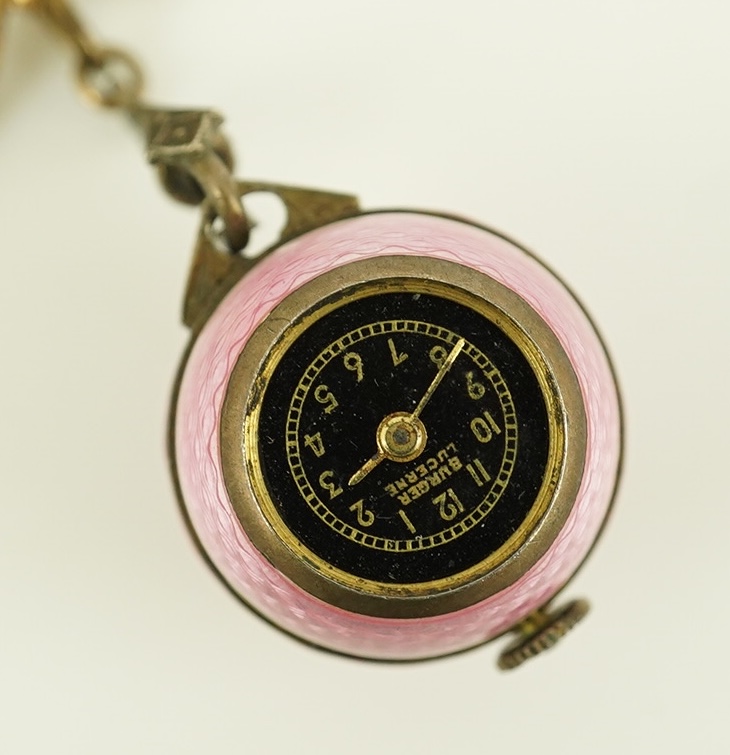 An early to mid 20th century silver and pink guilloche enamel Burger manual wind globe lapel watch, on a later 9ct gold ribbon bow suspension brooch